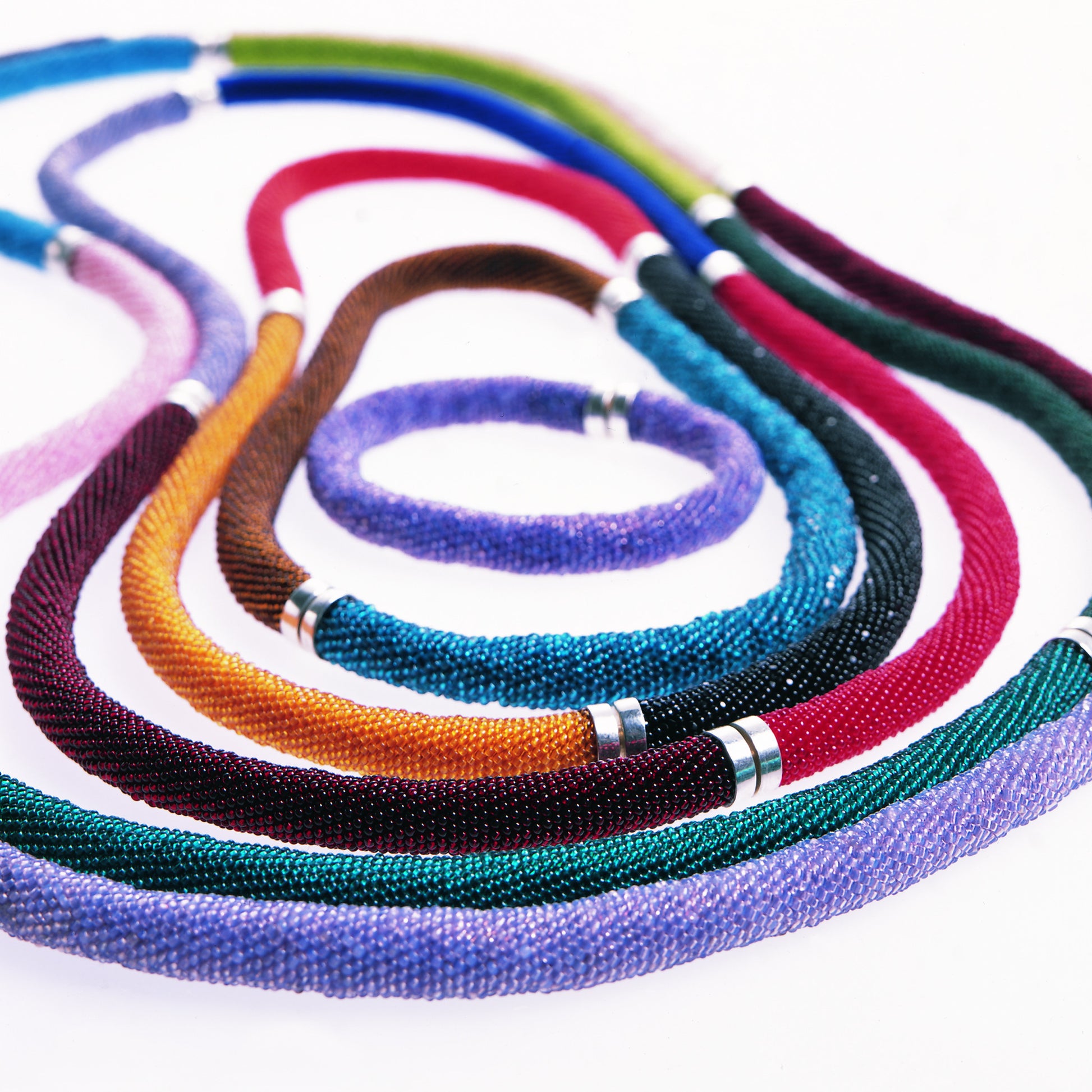 Glass bead bracelets coupled to form necklaces 